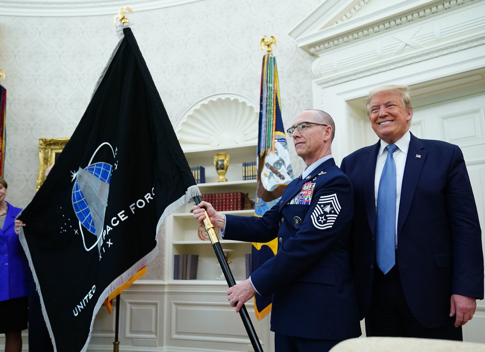 U.S.-Space-Force-senior-enlisted-adviser-Chief-Master-Sgt.-Roger-Towberman-presents-the-Space-Force-Flag-to-President-Trump-on-Friday-in-the-Oval-Office.